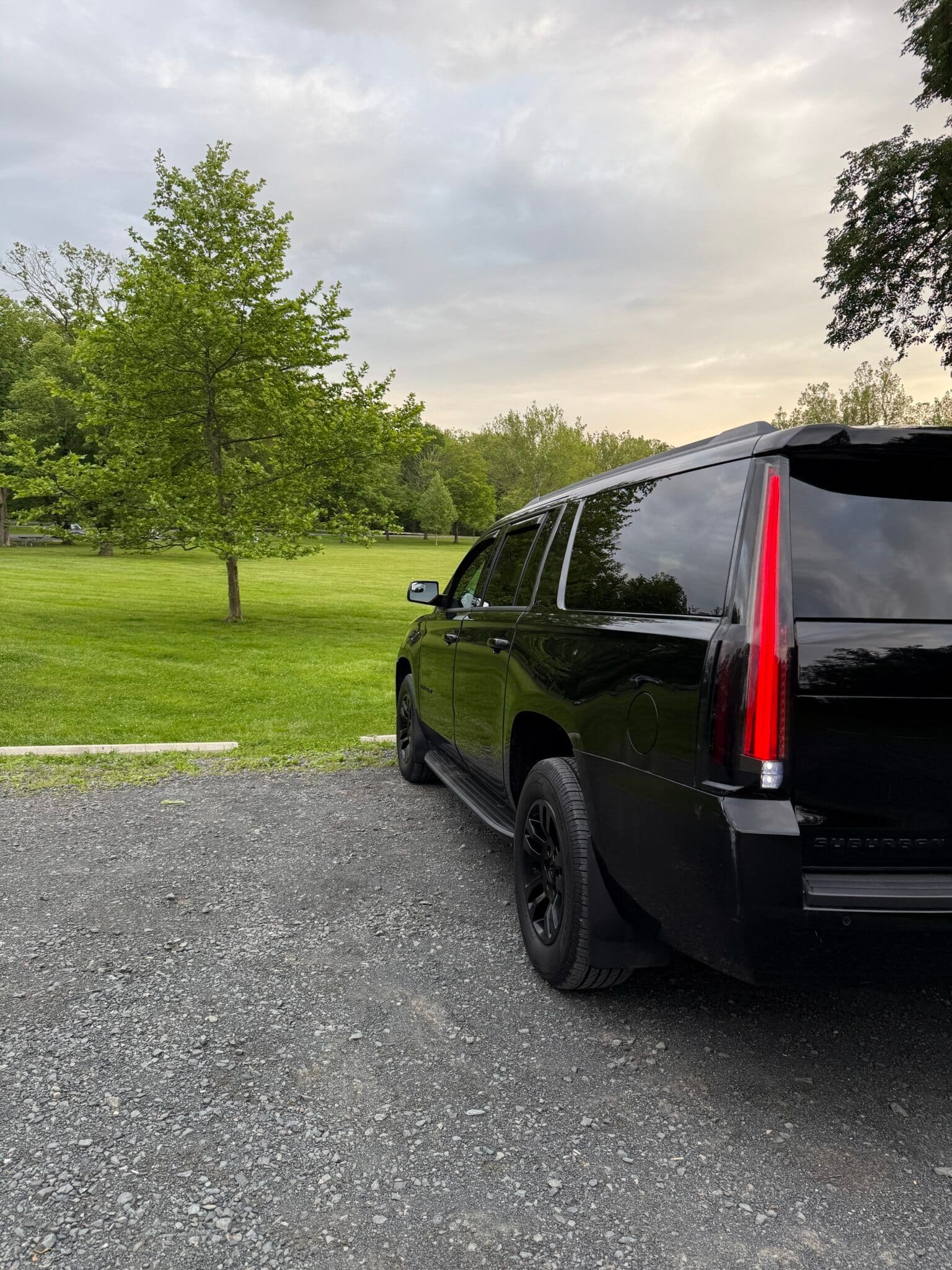 Black Cadillac Escalade ESV parked on gravel driveway near trees in Summit NJ
