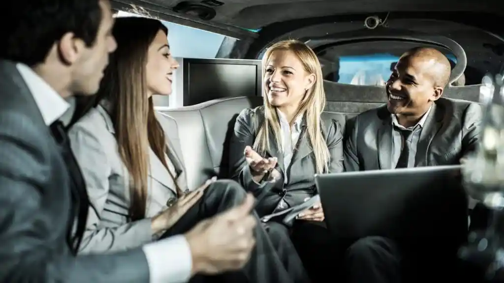 Business professionals networking inside a limousine during corporate transportation in Summit, NJ.