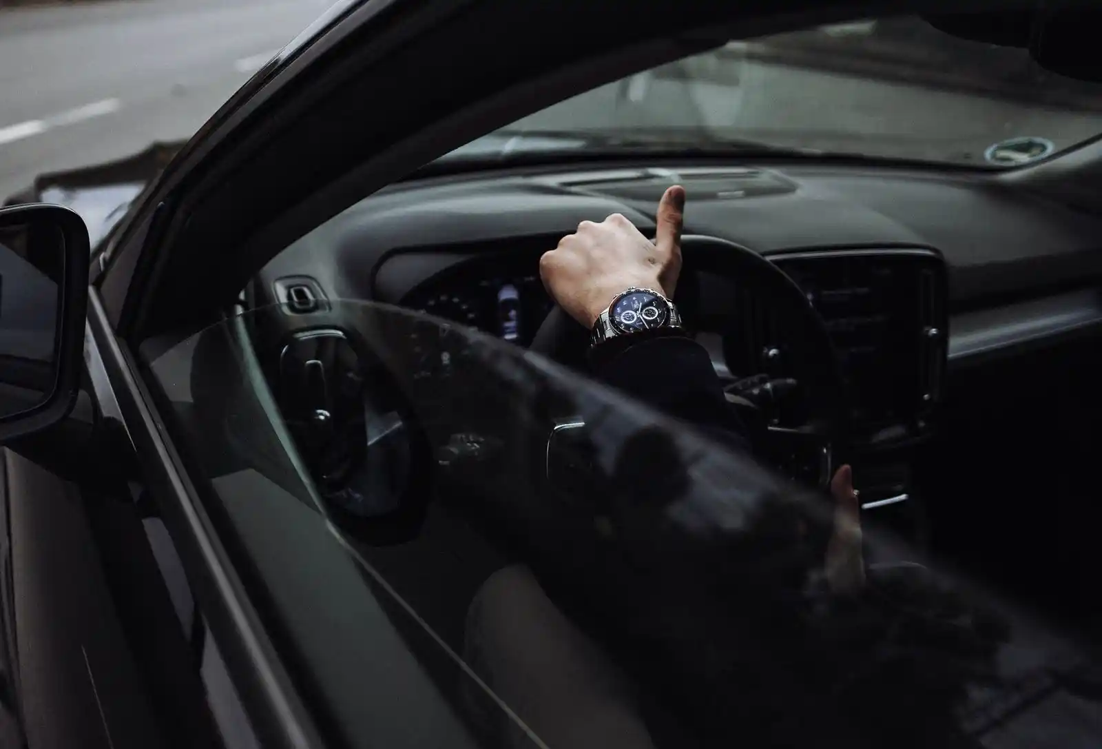 Chauffeur assisting passenger