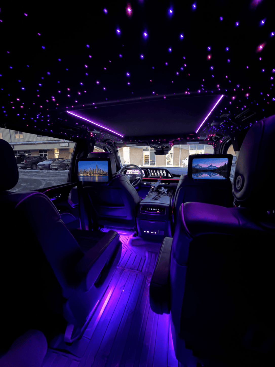 Escalade cabin with purple starlight ceiling, leather seating and rear entertainment screens